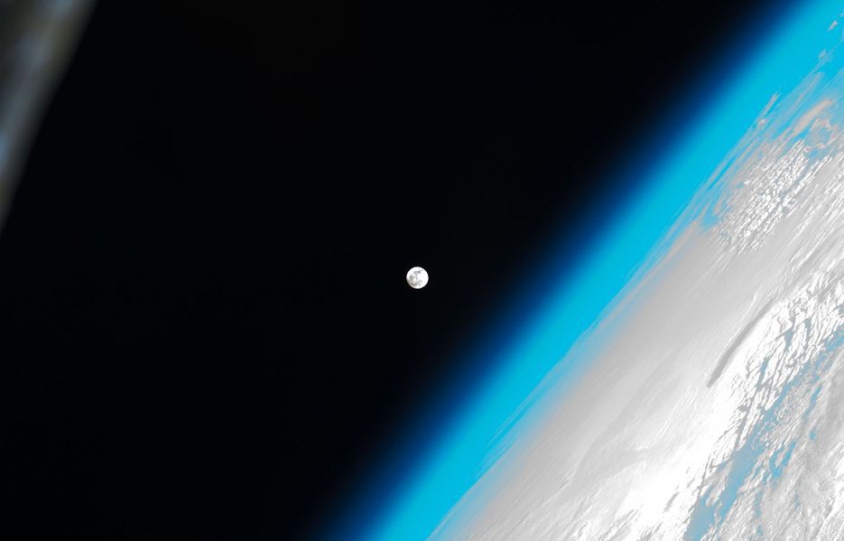 This stunning photo shows the moon and Earth's atmosphere as seen from the International Space Station. Image from NASA