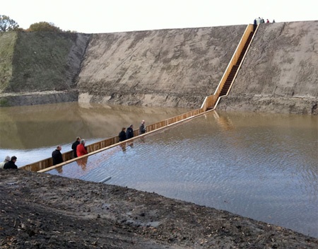 Pedestrian bridge near Fort de Roovere in the Netherlands divides the water like Moses.. Designed by RO architects