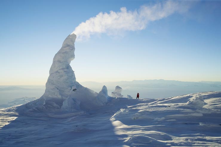 Mount Erebus, an active volcano in Antarctica, has a permanent lake of molten lava just below its 13,000 ft. summit. On the flanks of Erebus are steam vents that have formed towers of frozen geothermal vapor. Image by George Steinmetz